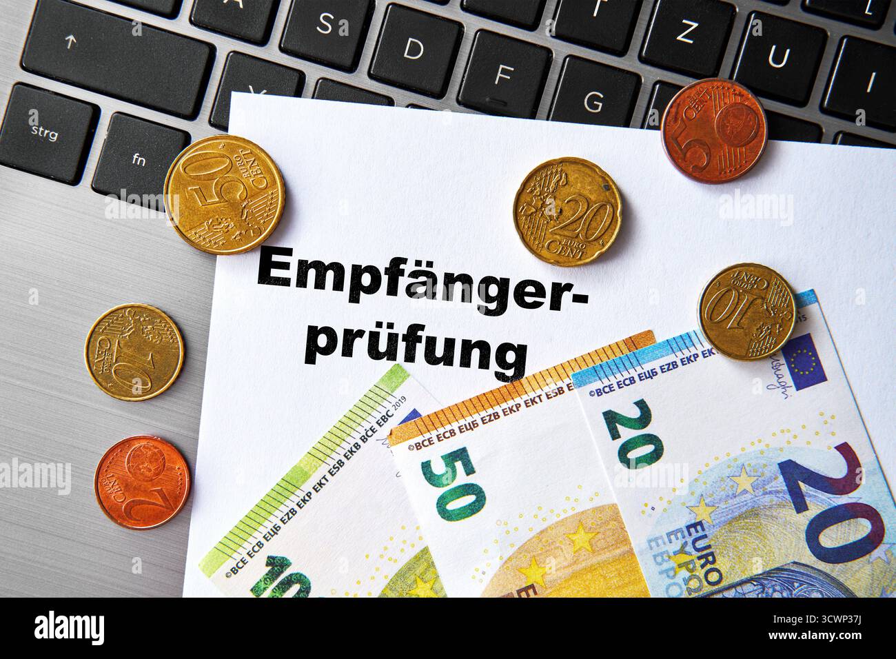 Bavière, Allemagne - 11 octobre 2025 : ASSEMBLAGE DE PHOTOS, Un document avec l'inscription : chèque du destinataire, repose sur un clavier d'ordinateur portable, entouré de pièces en euros et de billets de banque. Photo symbolique pour la vérification des bénéficiaires des virements bancaires en vertu des nouvelles réglementations SEPA et IBAN *** FOTOMONTAGE, Ein Dokument mit der Aufschrift : Empfängerprüfung, liegt auf einer Laptop-Tastatur, umgeben von Euro-Münzen und Geldscheinen. Symbolfoto für die Prüfung von Zahlungsempfängern BEI Banküberweisungen im Rahmen neuer SEPA- und IBAN-Regelungen Banque D'Images