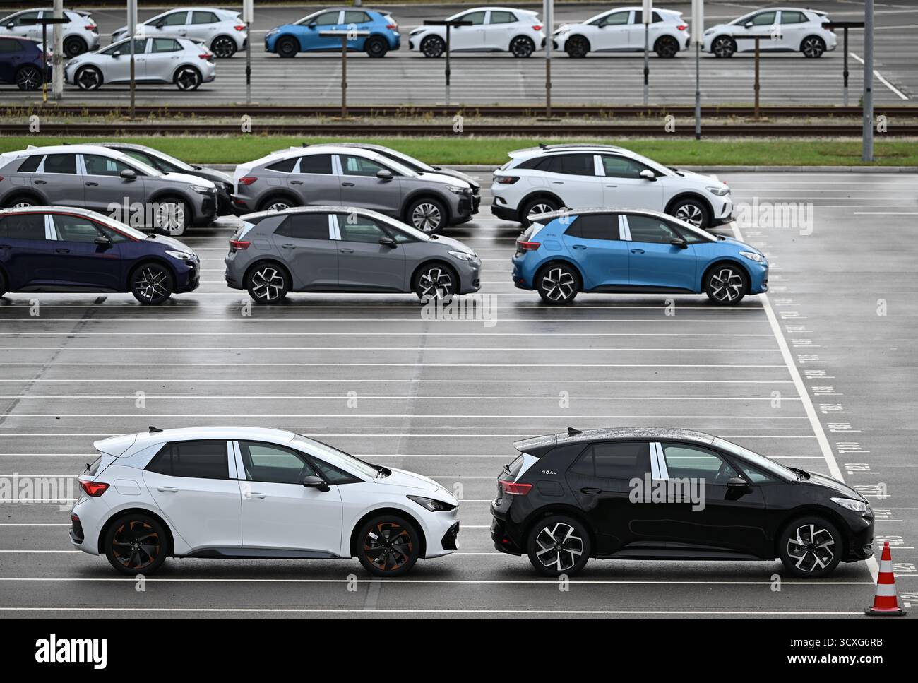 Zwickau, Allemagne. 13 octobre 2025. Les véhicules électriques de l’usine Volkswagen de Zwickau attendent d’être livrés dans un parking d’usine. Jusqu’à présent, six modèles Volkswagen, Audi et Cupra ont quitté la chaîne de production de l’usine de Saxe. L'usine de Zwickau ne fonctionne pas actuellement à pleine capacité. La capacité est de plus de 300 000 véhicules par an ; selon la direction, elle est actuellement un peu plus de 200 000. Crédit : Hendrik Schmidt/dpa/Alamy Live News Banque D'Images