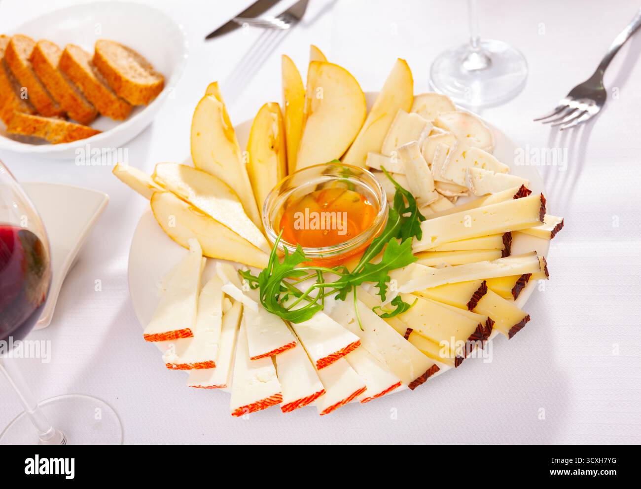 Différents types de fromage et de tranches de poire sur l'assiette Banque D'Images