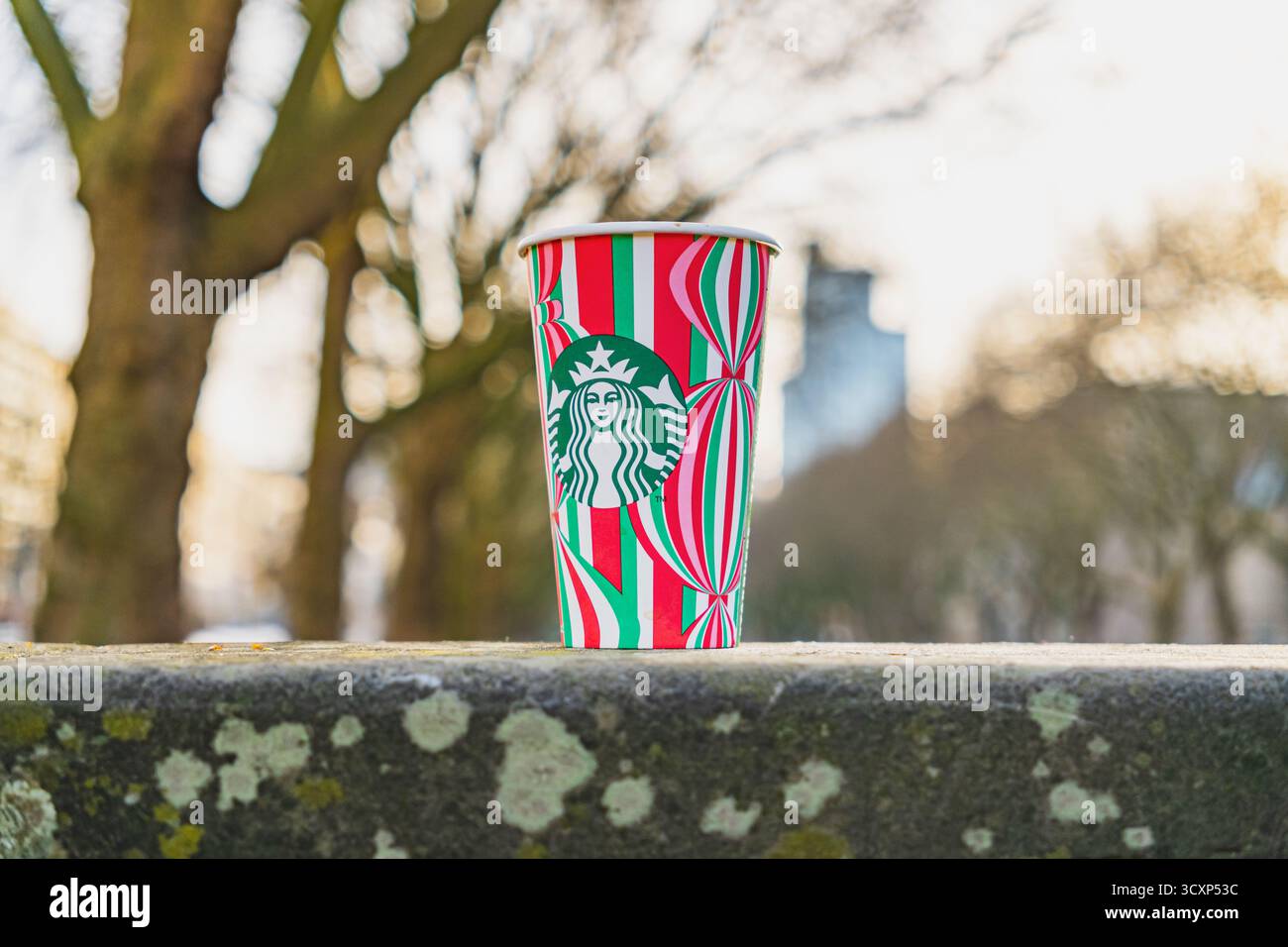 Tasse Starbucks festive avec fond de ville d'hiver flou Banque D'Images