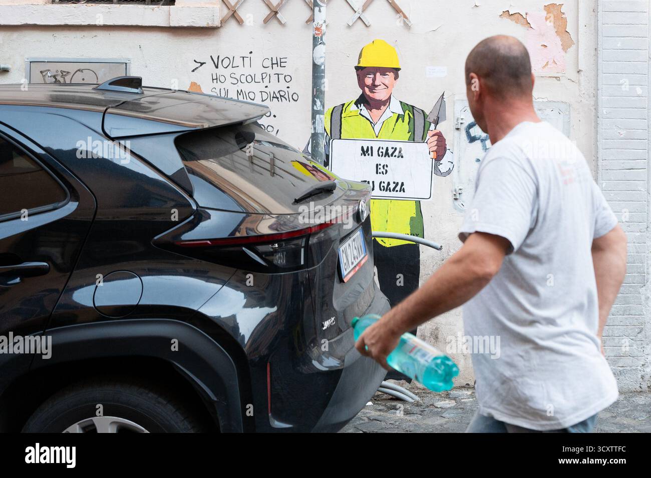 Rome, Italie. 15 octobre 2025. Un graffiti de TV BOY représente le président américain Donald Trump comme un travailleur de la construction avec une casquette jaune, avec une légende de l'artiste lisant ''me Gaza es tu Gaza''. Il apparaît dans une rue de Trastevere, Rome, Italie, le 15 octobre 2025. (Photo de Massimo Valicchia/NurPhoto) crédit : NurPhoto SRL/Alamy Live News Banque D'Images