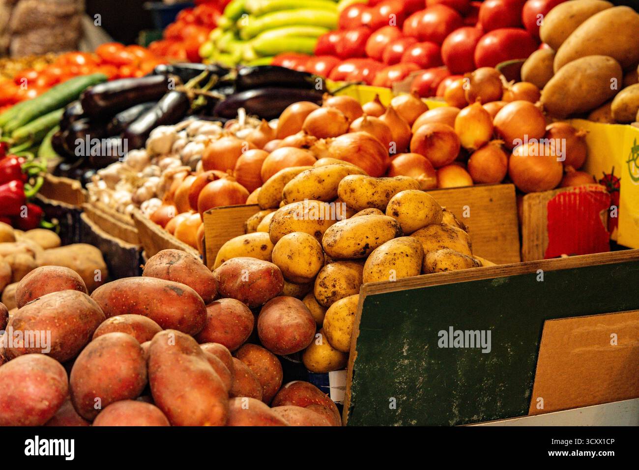 Légumes frais colorés exposés sur les étals du marché à Kutaisi Géorgie : tomates, poivrons, aubergines, oignons et concombres symbolisant la récolte locale Banque D'Images