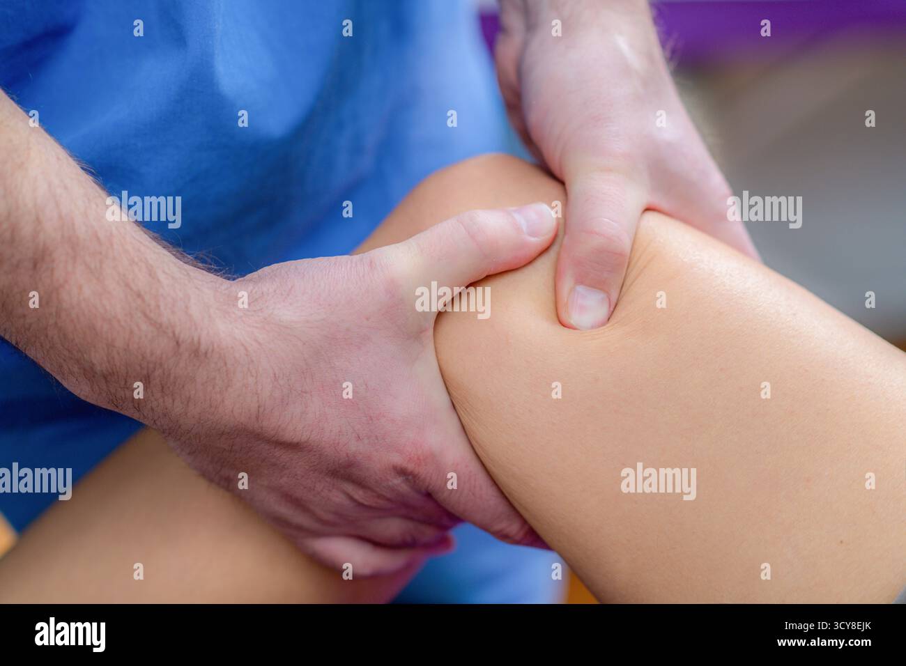 Femme recevant un massage du genou pendant une séance de physiothérapie pour soulager la tension musculaire, améliorer la circulation et réduire les douleurs articulaires. Banque D'Images