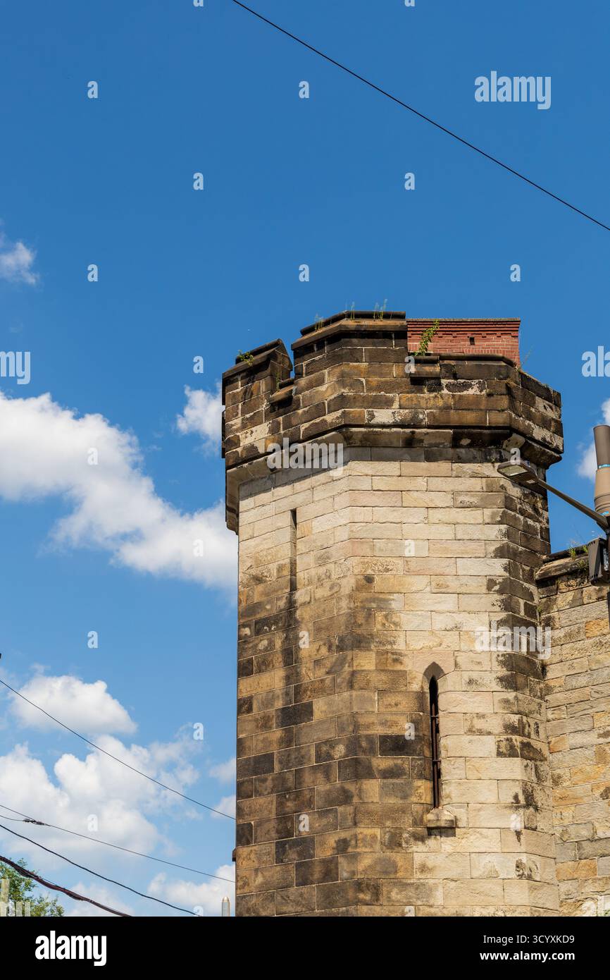 Une tour de château avec un toit en briques et une cheminée. Le ciel est bleu avec quelques nuages. Pénitencier de l'État oriental Banque D'Images Une tour de château avec un toit en briques et une cheminée. Le ciel est bleu avec quelques nuages. Pénitencier de l'État oriental Banque D'Images