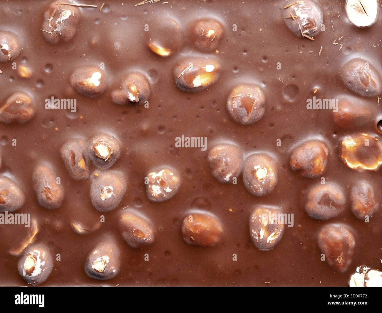 Chocolat avec noisettes comme fond Banque D'Images