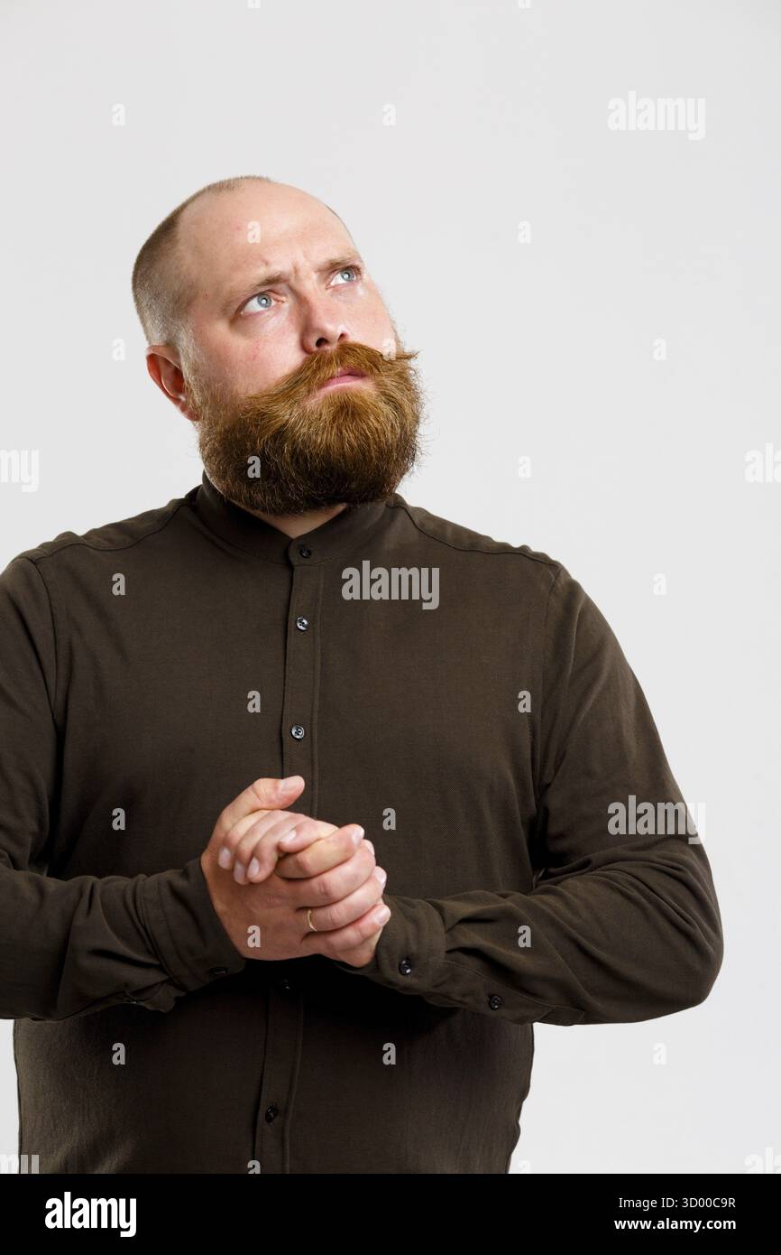 Santa Claus dans brown chemise avec barbe et moustache au gingembre sur fond gris vide Banque D'Images