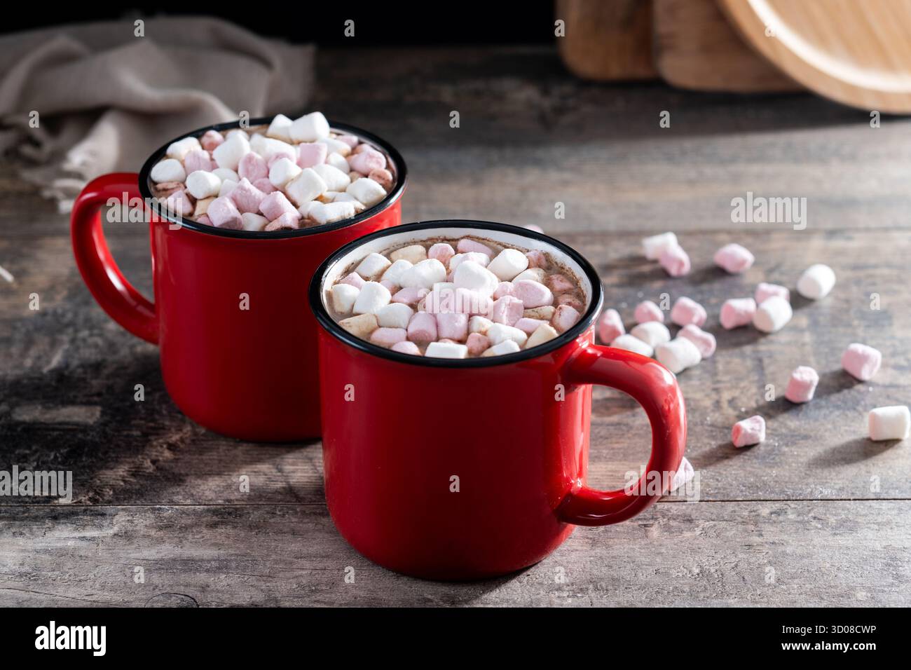 Boisson au chocolat chaud avec des guimauves dans une tasse rouge sur une table en bois Banque D'Images