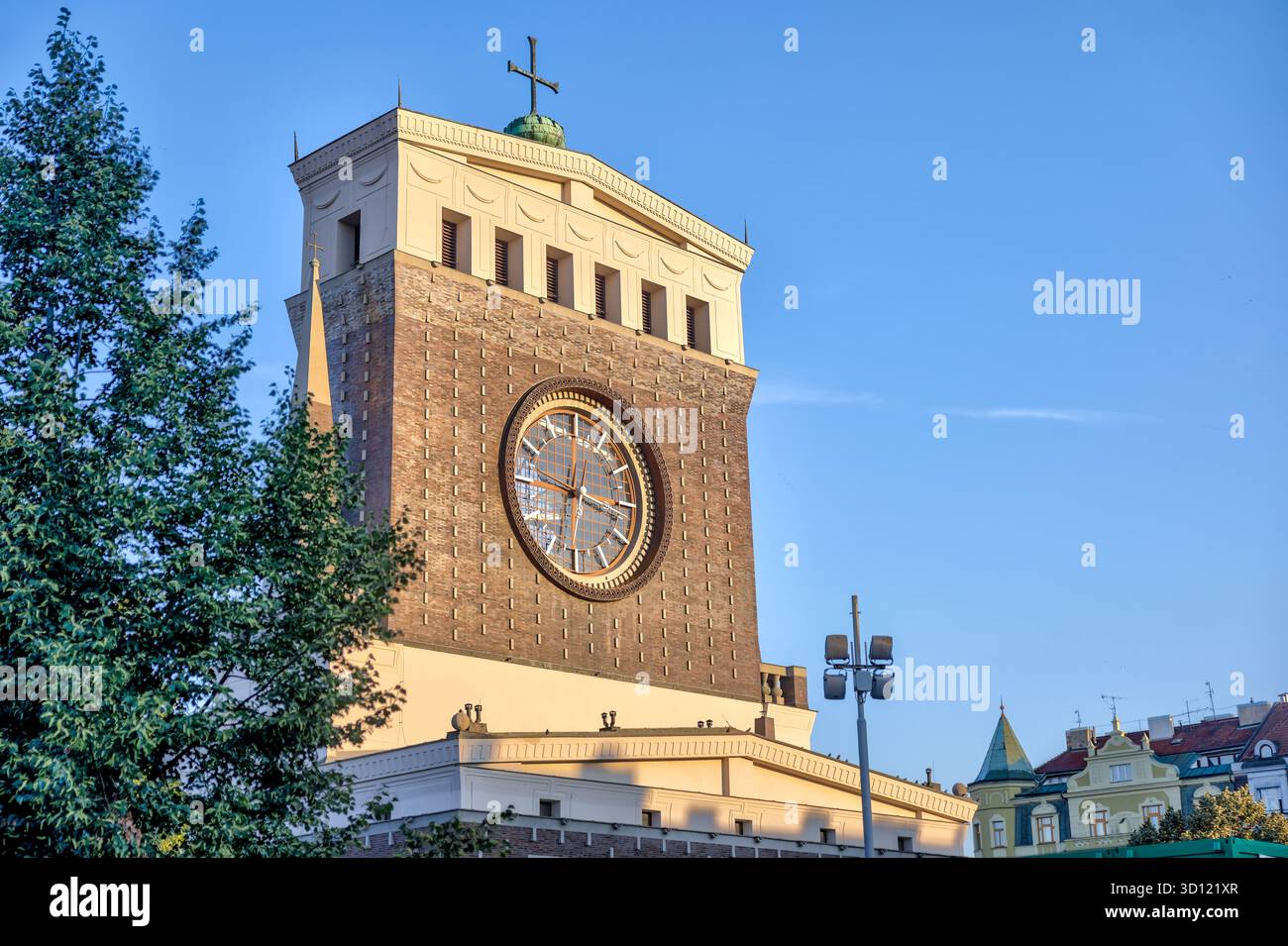 Église du très Sacré-cœur de notre Seigneur à Prague, République tchèque, avec sa tour de l'horloge distinctive éclairée par la lumière du soleil tôt le matin. Banque D'Images
