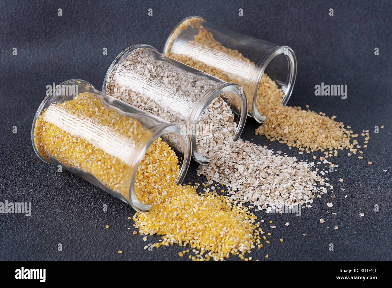 Le millet, la farine d'avoine et les gruaux d'orge se sont répandus des bocaux Banque D'Images