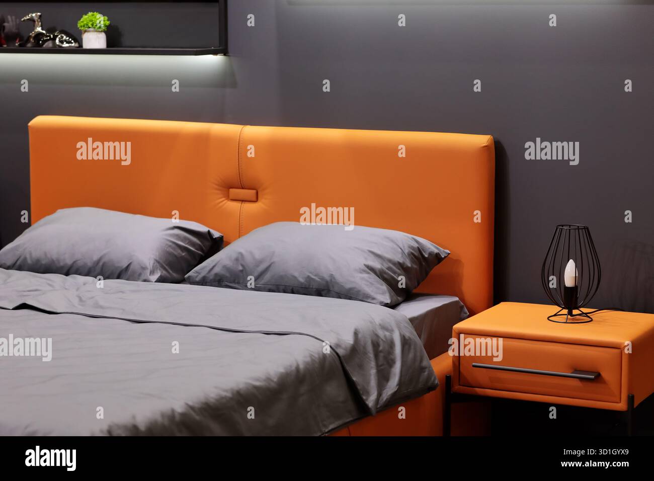 Intérieur de la chambre de style minimaliste moderne dans des tons gris et orange. Mise au point sélective. Banque D'Images