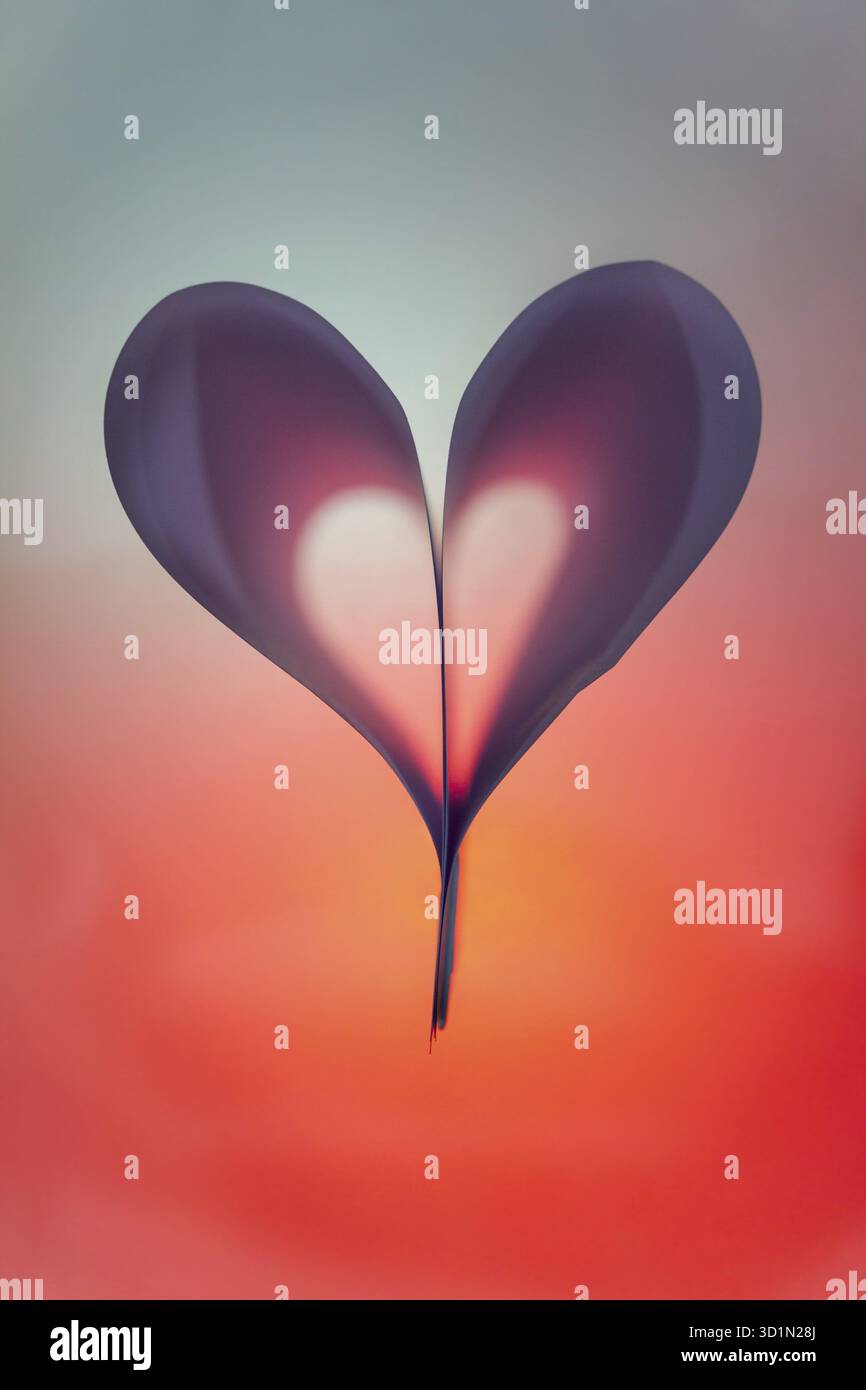 Papier rétro-éclairé plié en forme de coeur abstrait suitabe comme papier peint. Faible profondeur de champ Banque D'Images