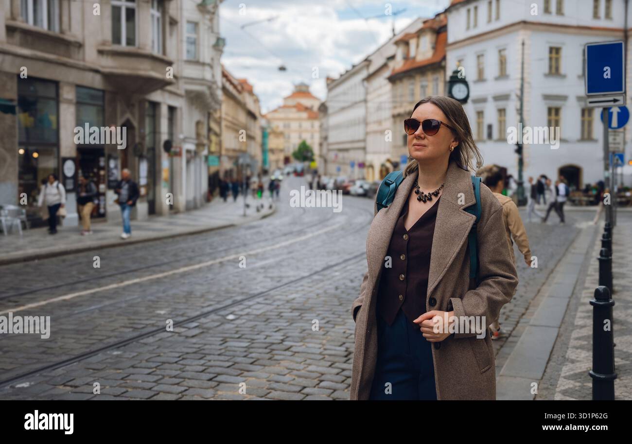 Femme élégante sur la rue pavée dans la ville européenne. Banque D'Images