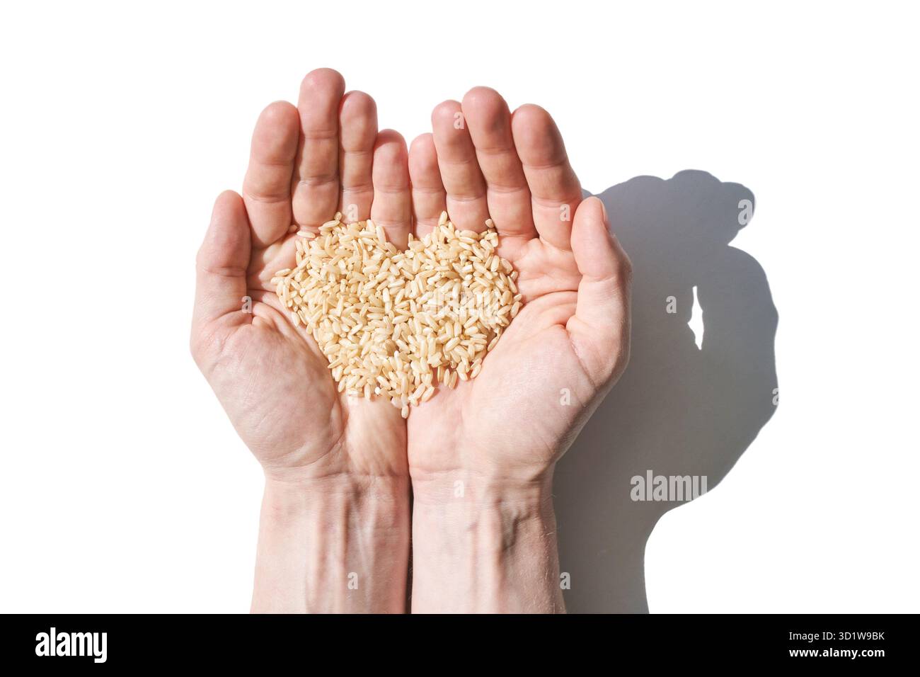 Un tas de riz en forme de cœur, symbolisant l'amour, l'unité et l'espoir. Les grains, divers Banque D'Images