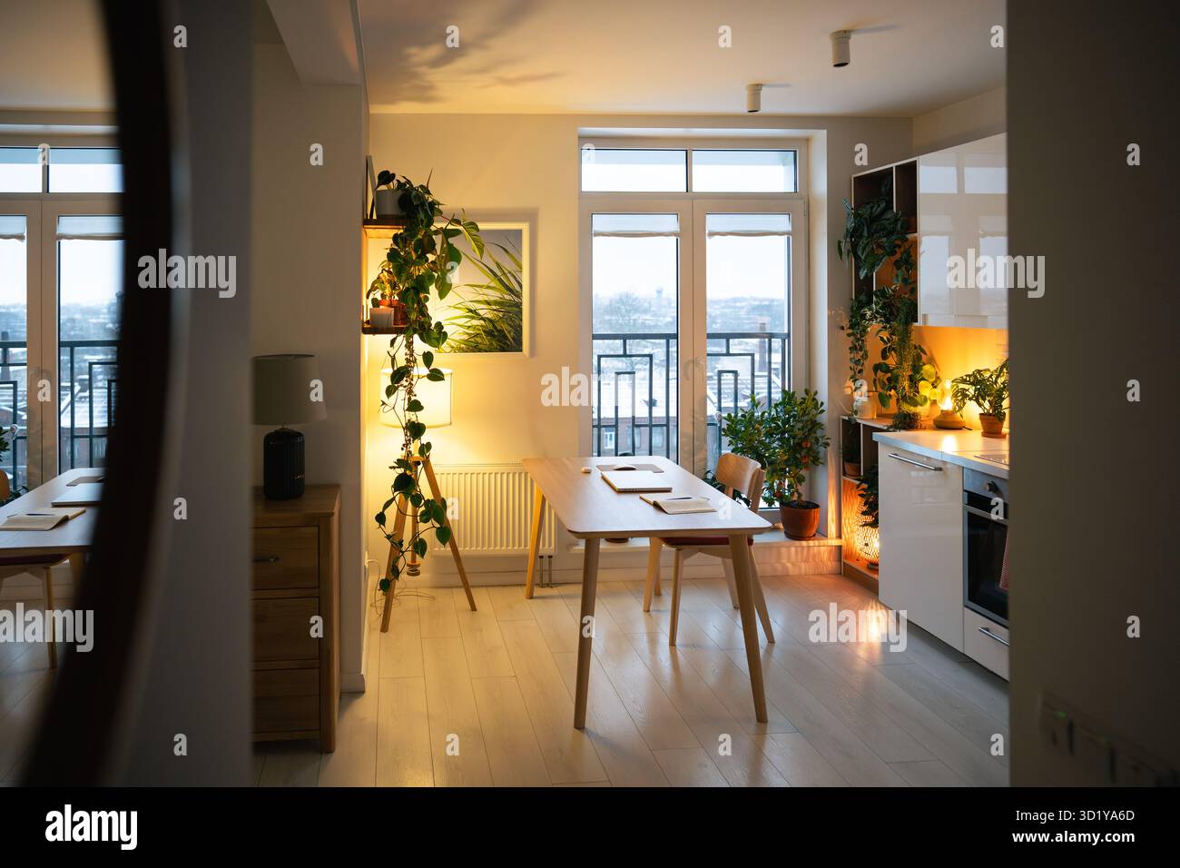 Intérieur accueillant de l'appartement avec lumière douce de la lampe reflet dans le miroir, cuisine et couloir lumineux chaud Banque D'Images