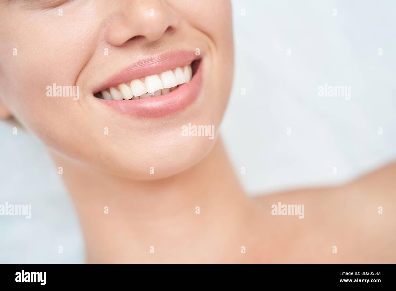 Gros plan de femme caucasienne souriante avec des dents parfaites et une peau lisse Banque D'Images