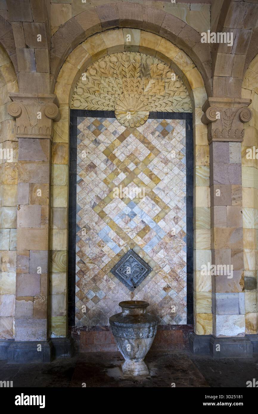 Mosaïque détaillée avec des motifs décoratifs et des reliefs sur le mur au-dessus d'une cruche en pierre, source, galerie d'eau minérale à Jermuk, source minérale, santé re Banque D'Images