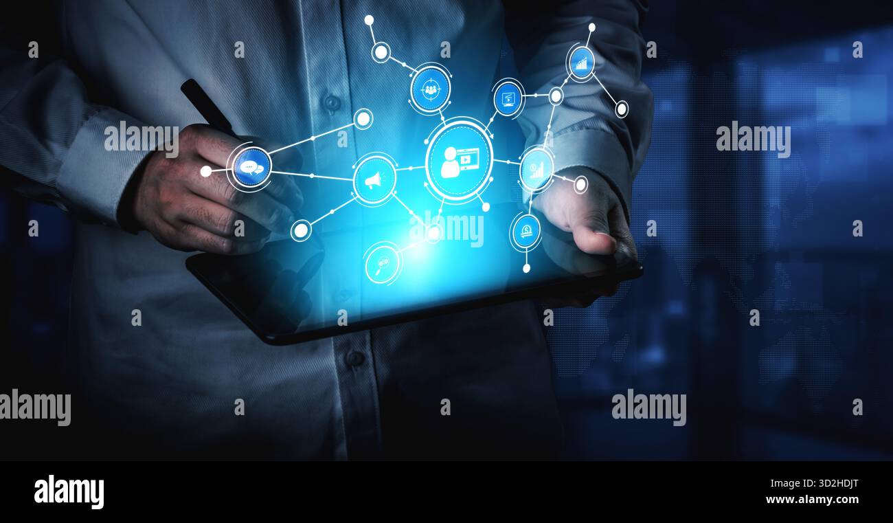 Un professionnel des affaires s'engage avec une tablette, illustrant les connexions numériques à travers des icônes vibrantes. Cette image illustre l'innovation et la technologie i. Banque D'Images