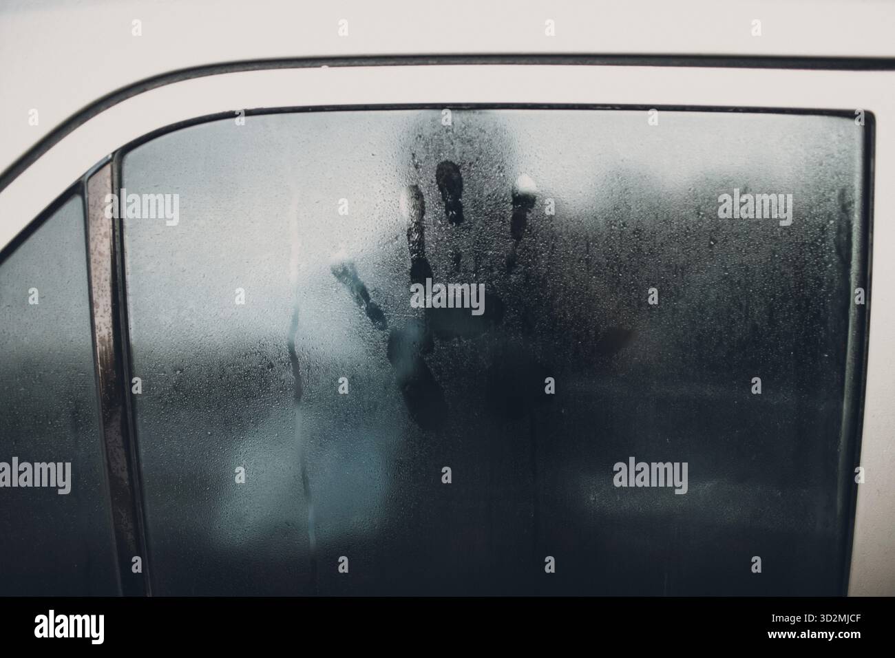 La pluie et l'empreinte sur le verre de voiture Banque D'Images