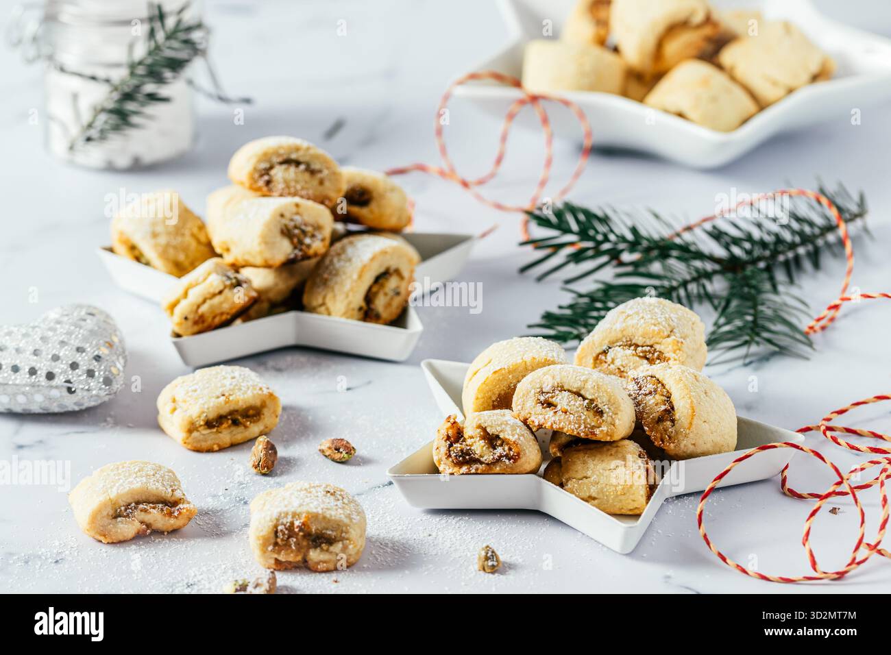 Biscuits de pâte brisée avec remplissage à la pistache, cuisson de Noël, rouleaux de pistache sur fond blanc Banque D'Images