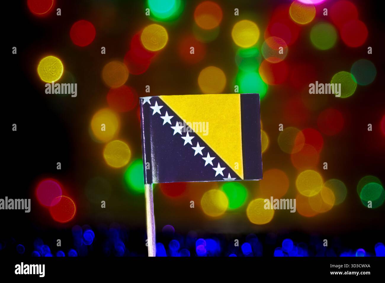 Drapeau de Bosnie-Herzégovine sur fond de bokeh lumineux et coloré. Souligner la fierté des Balkans, l'unité européenne et les grandes célébrations nationales. Banque D'Images