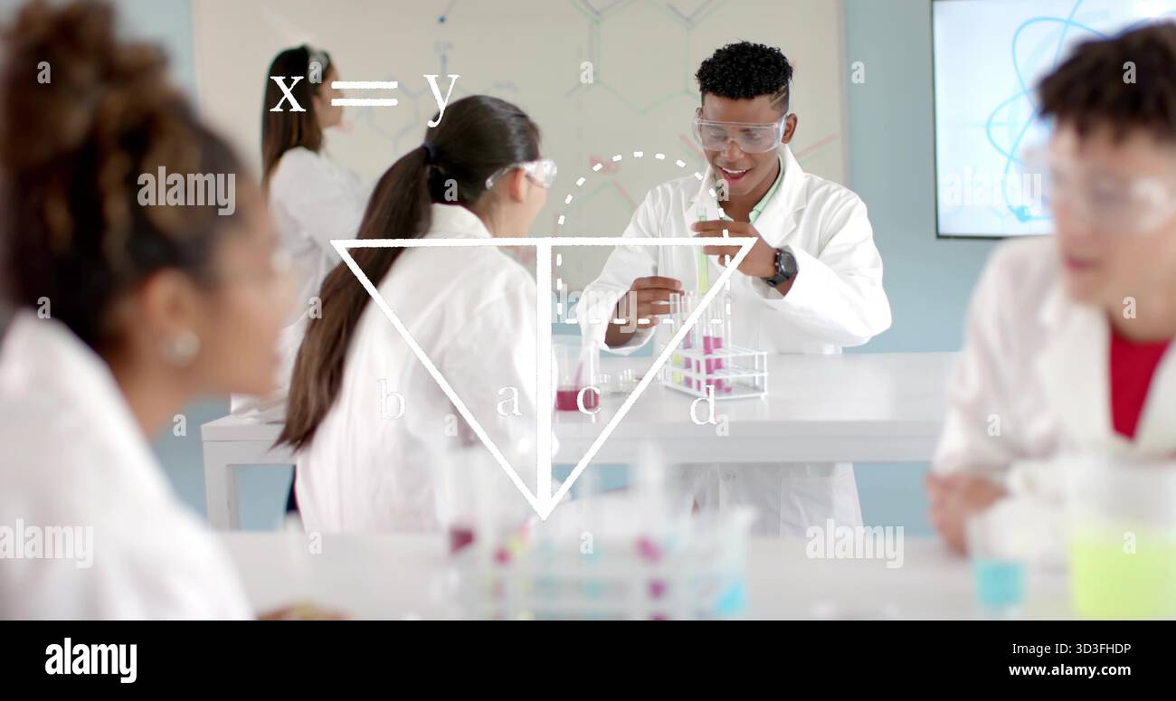 Transfert de liquides étudiants dans des blouses de laboratoire et des lunettes de protection au laboratoire de l'école, à l'aide de pipettes et de tubes à essai Banque D'Images