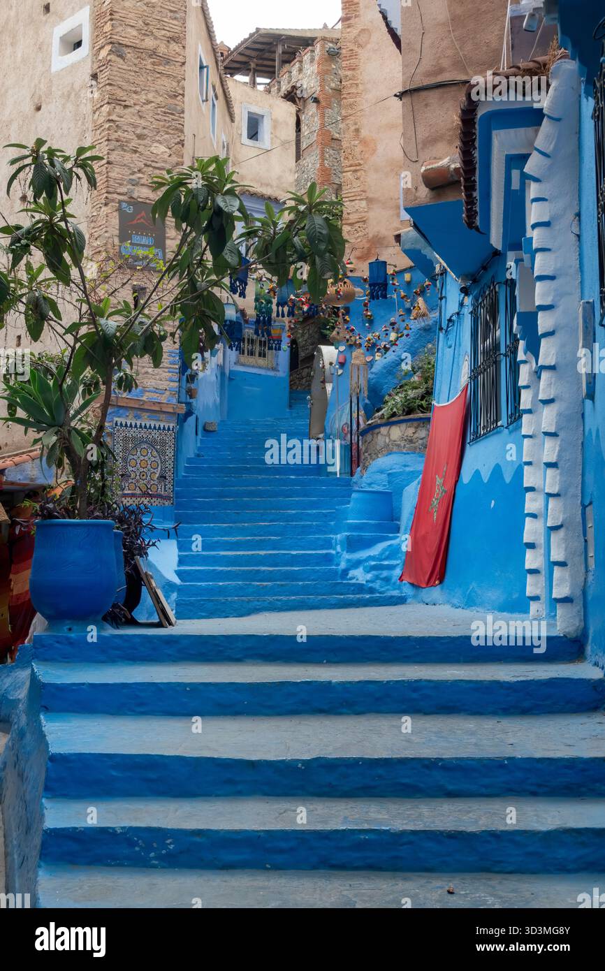 Chefchaouen, Maroc-26 octobre 2025 : escalier emblématique de Chefchaouen, peint dans des tons de bleu. Lampes et décorations marocaines accrochées au-dessus des marches, Banque D'Images