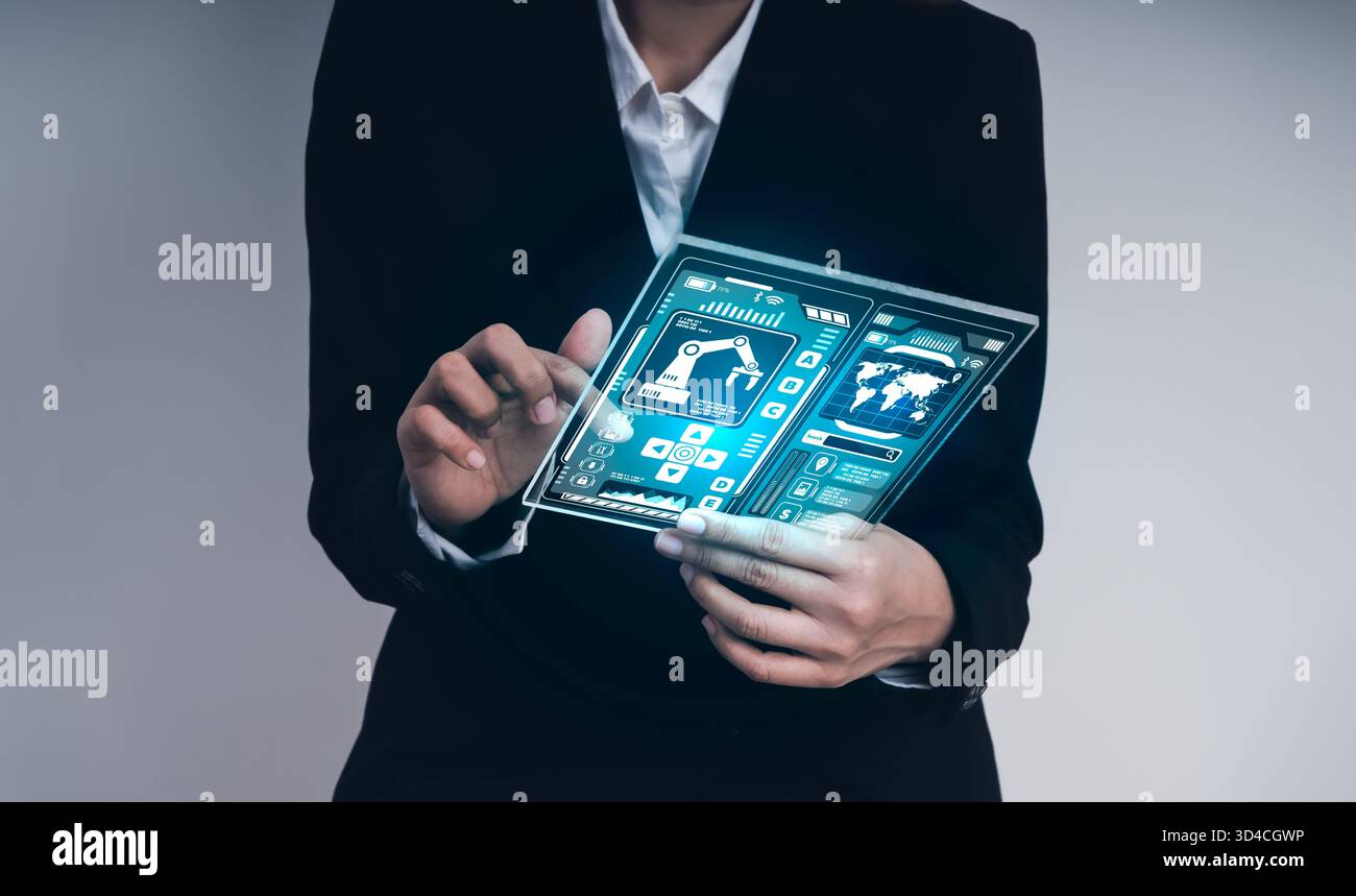 Homme d'affaires utilisant une tablette futuriste transparente avec tableau de bord de contrôle robotique, symbolisant l'ingénierie robotique, l'automatisation intelligente, l'interfac high-tech Banque D'Images
