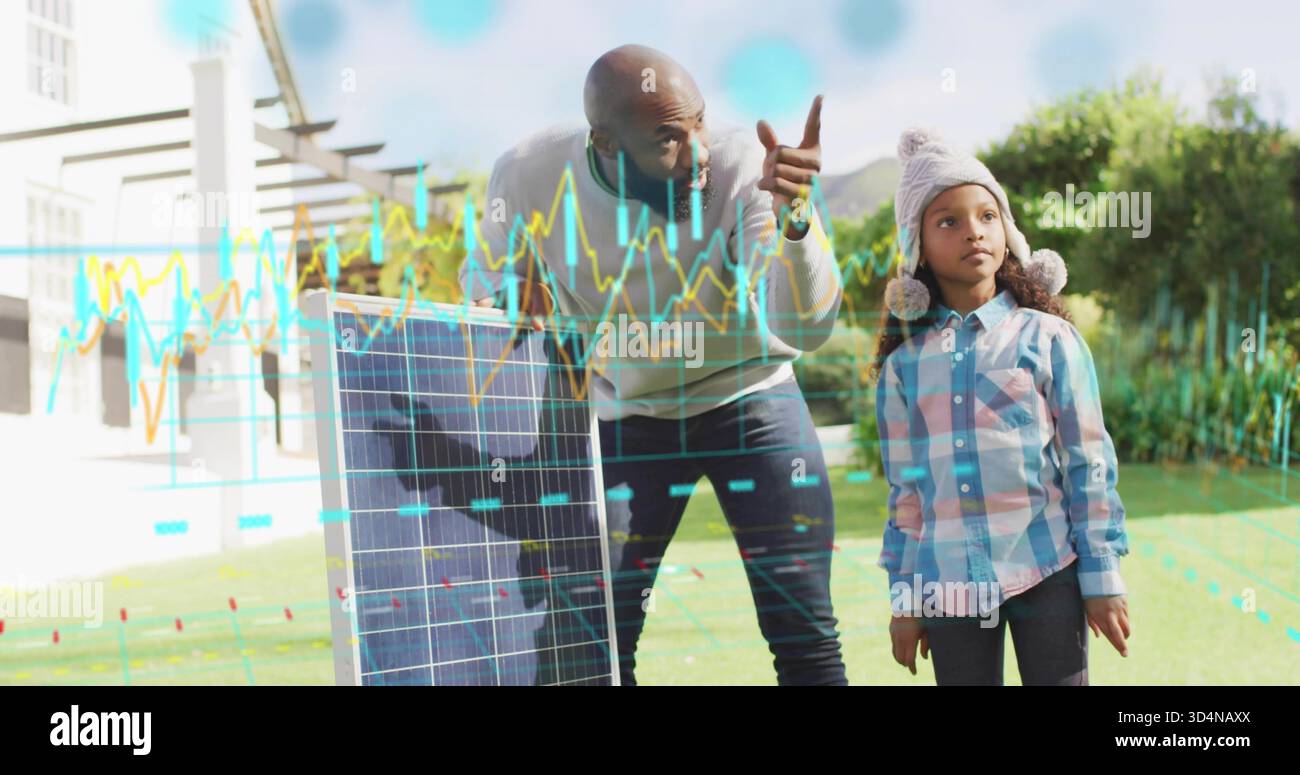 Pointant l'homme dans le pull enseignant la fille dans le chapeau pompon dans la cour avant, montrant des données de panneau solaire Banque D'Images
