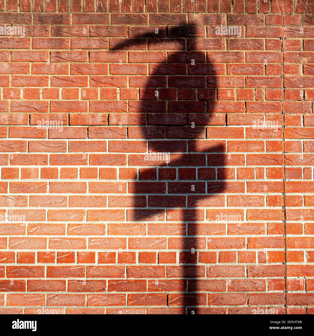 Ombre du panneau de signalisation sur le mur Banque D'Images