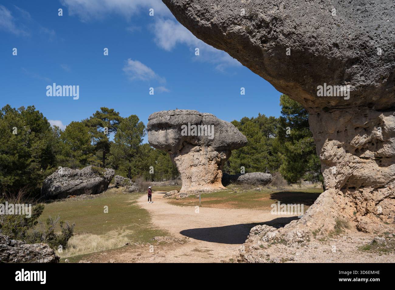 Dans un lointain une femme méconnaissable marche seule parmi les formations rocheuses uniques à la Ciudad Encantada, Cuenca, Castilla-la Mancha, Espagne, showcasin Banque D'Images