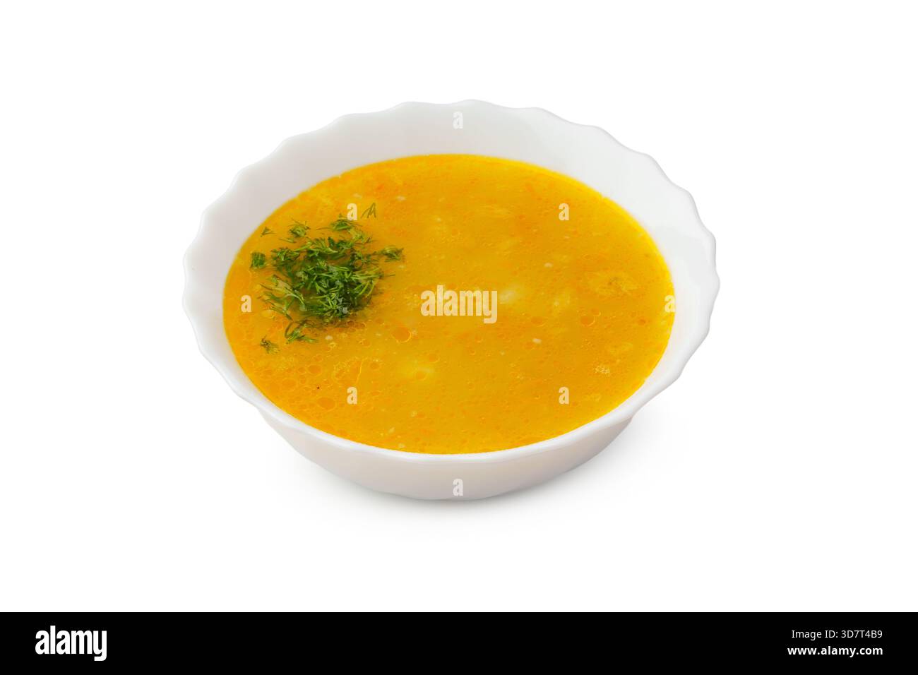 Soupe de lentilles jaunes garnie d'herbes fraîches dans un bol blanc Banque D'Images