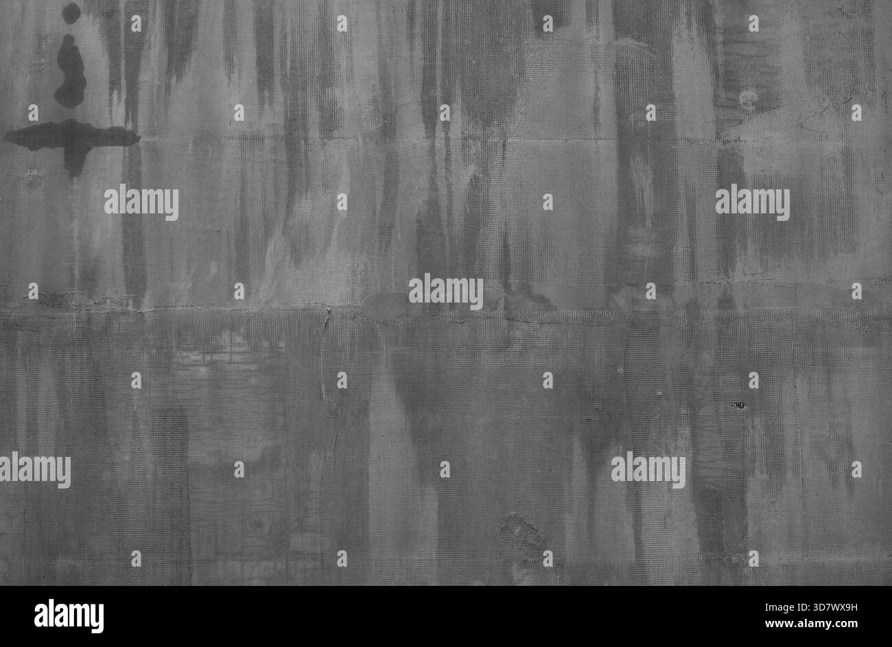 Mur de béton gris affichant une surface gritty altérée par les intempéries avec des traînées d'eau, une texture rugueuse et des imperfections visibles, créant un fort grunge et un fond industriel Banque D'Images