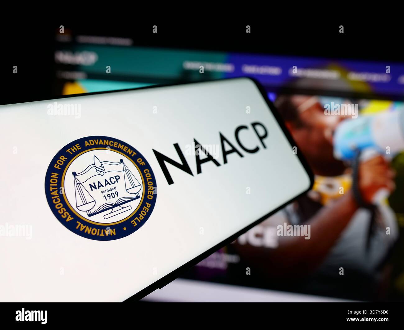 Stuttgart, Allemagne - 11-19-2025 : smartphone avec le logo de l'association américaine de personnes de couleur NAACP sur l'écran devant le site Web. Banque D'Images