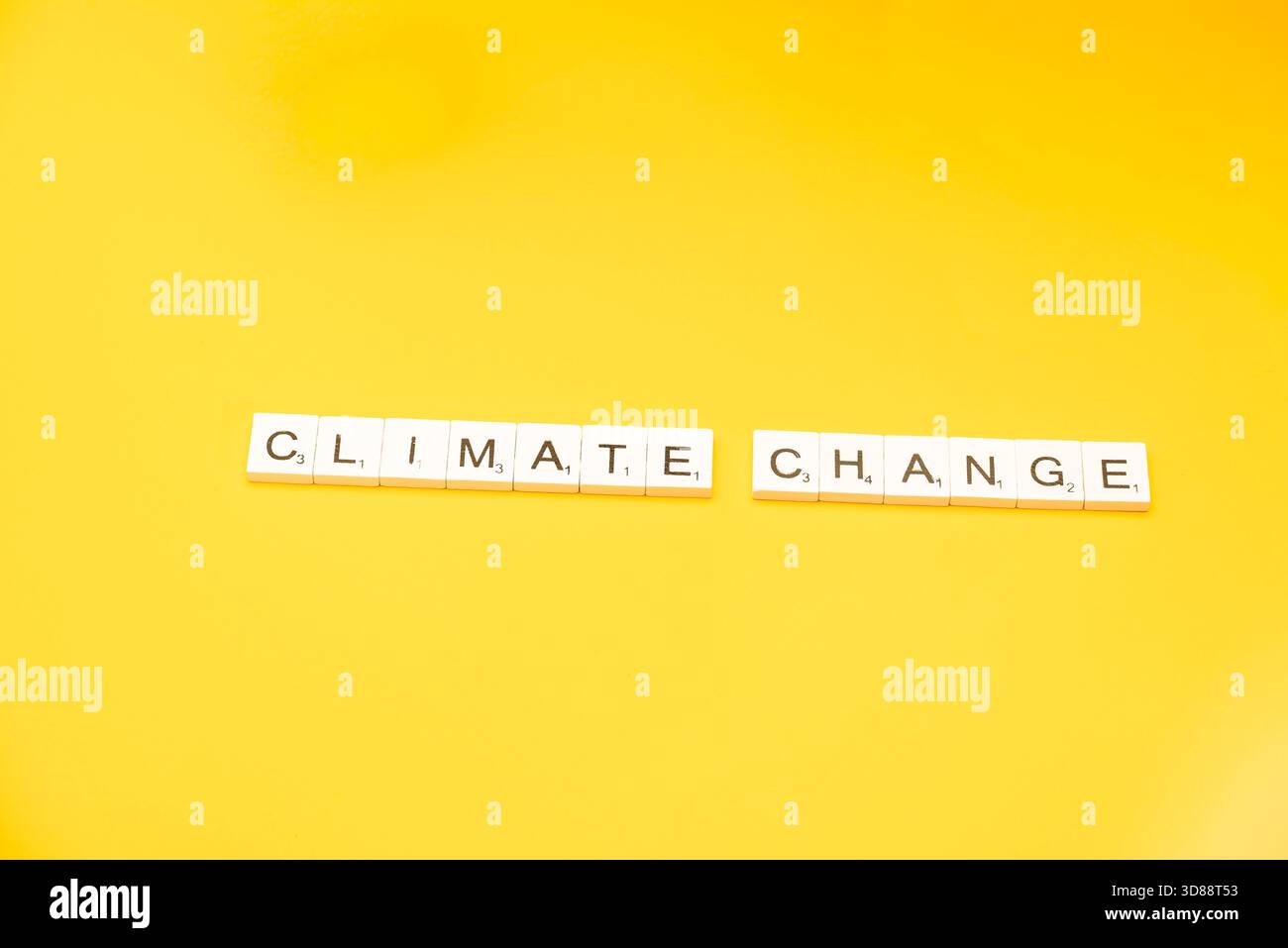 Les tuiles de mots écrivent « CHANGEMENT CLIMATIQUE » sur fond jaune, soulignant l'urgence de la question mondiale. Banque D'Images