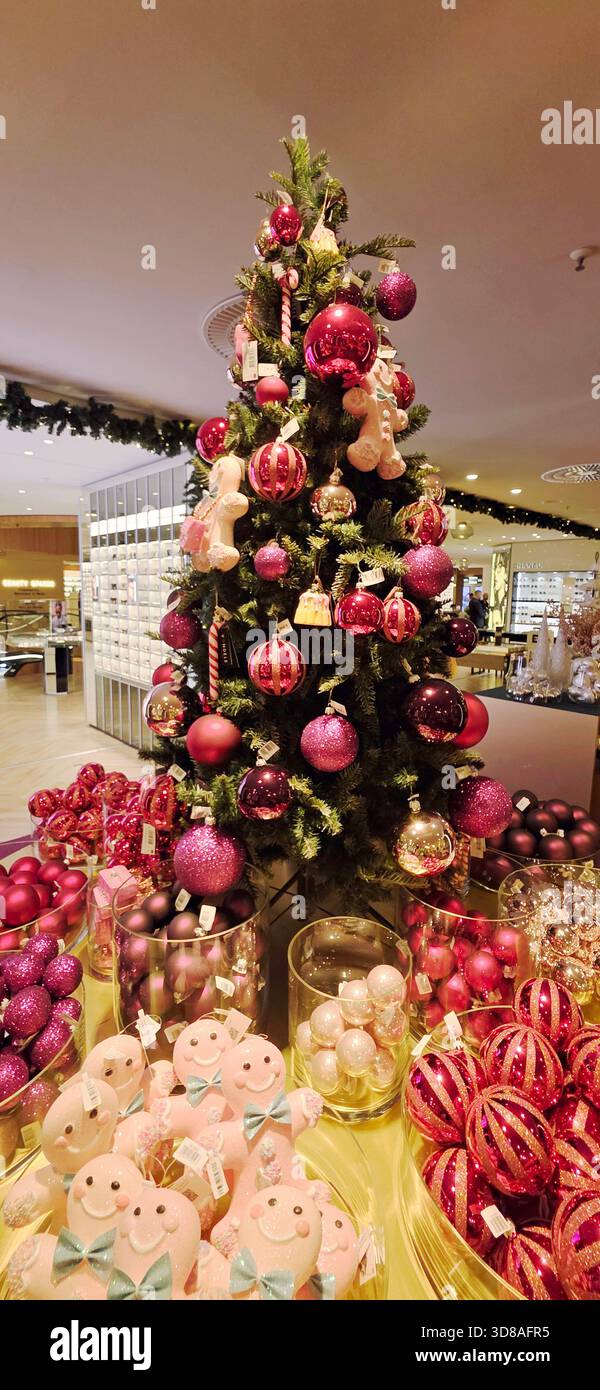 Berlin, Allemagne - 19 septembre 2025 : arbre de Noël orné d'ornements roses et entouré de décorations festives. - Image de stock capturée avec un smartphone
