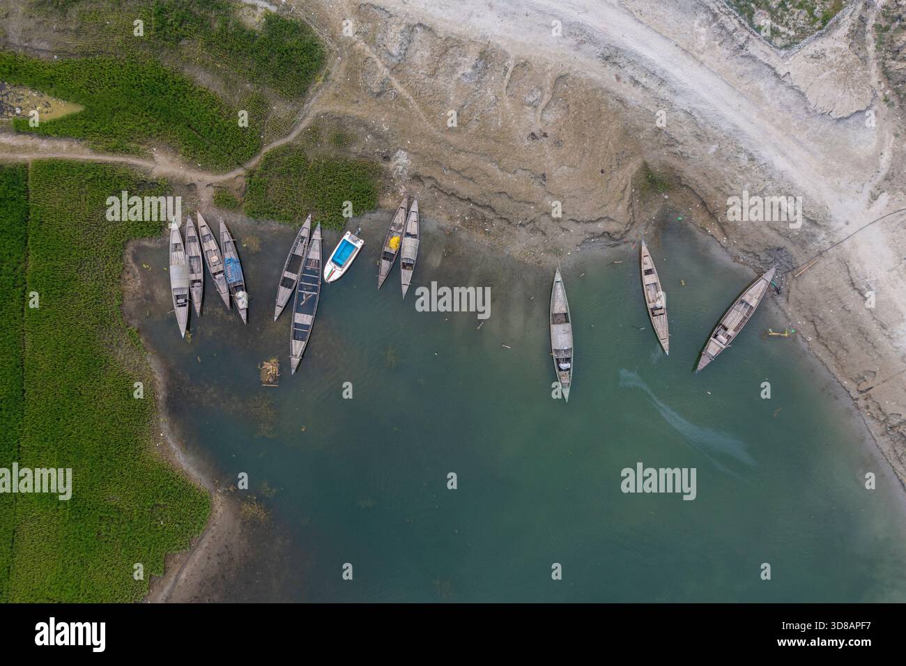 Des bateaux sont ancrés le long de la rive desséchée de la rivière Jamuna pendant l'hiver à Shariakandi, Bogra, Bangladesh. Banque D'Images