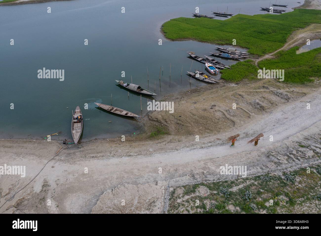 Des bateaux sont ancrés le long de la rive desséchée de la rivière Jamuna pendant l'hiver à Shariakandi, Bogra, Bangladesh. Banque D'Images