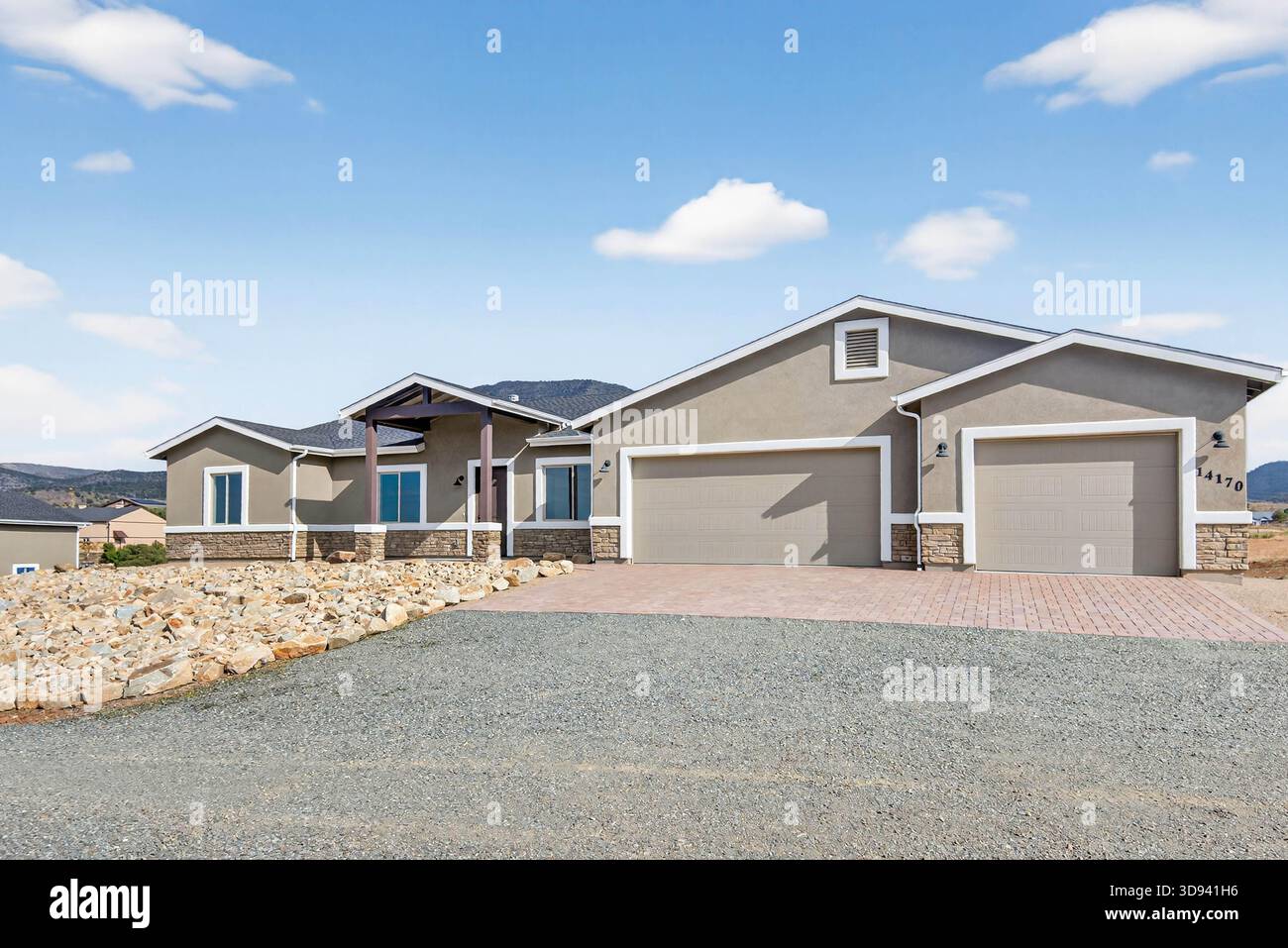 Façade élégante du Ranch avec garage pour trois voitures et entrée paysagée méticuleusement entretenue Banque D'Images