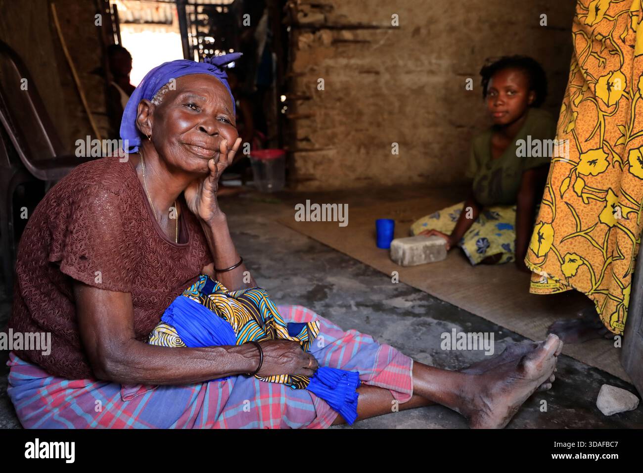 Une femme âgée avec une jeune femme assise sur le sol à l'intérieur d'une maison dans la ville de Macuti sur l'île de Mozambique, Mozambique Banque D'Images
