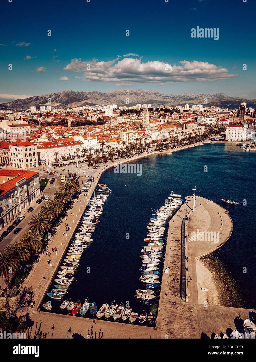 Vue aérienne du port animé de la promenade de Riva, palais de Dioclétien brillant sous le soleil, encadré par des montagnes lointaines et des eaux Azur, Split, Banque D'Images