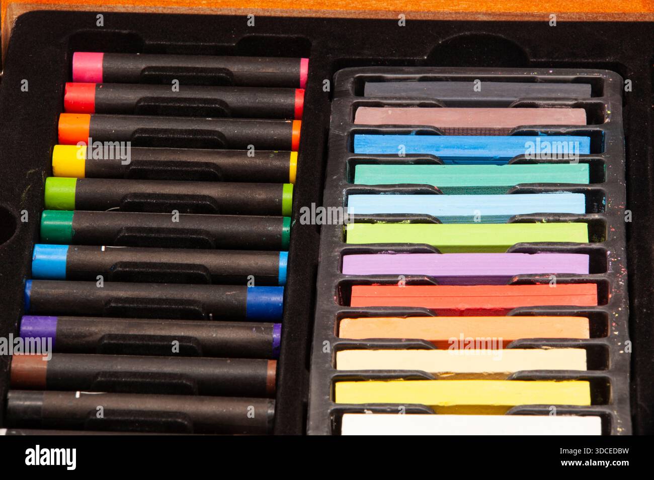 Ensemble d'art professionnel comprenant des pastels à l'huile et secs de différentes couleurs, soigneusement disposés dans un plateau. Gros plan des matériaux pour le dessin, la créativité, le design Banque D'Images