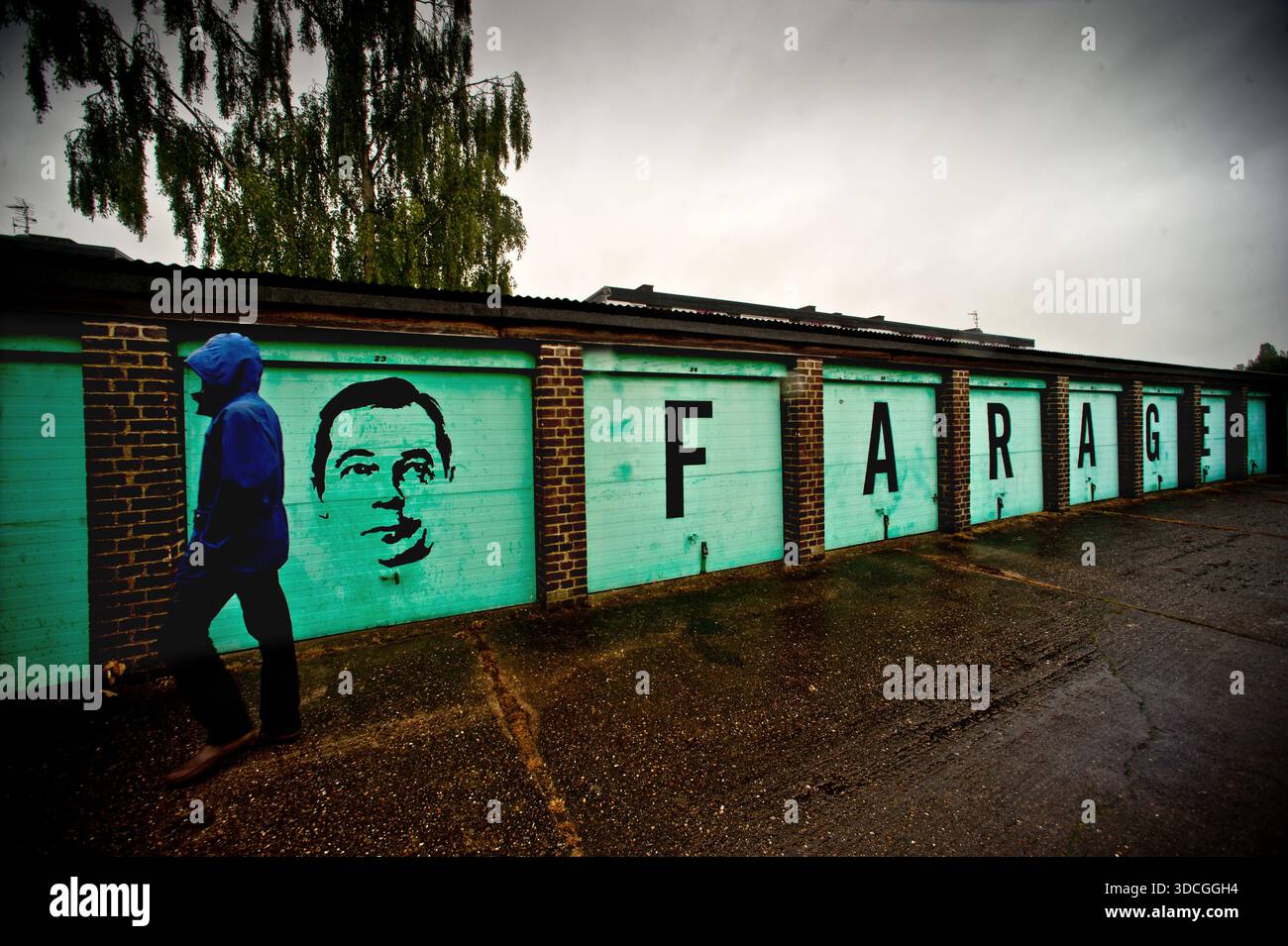 Une rangée de garages à Cambridge, Royaume-Uni graffinés avec une image de Nigel Farage. Banque D'Images