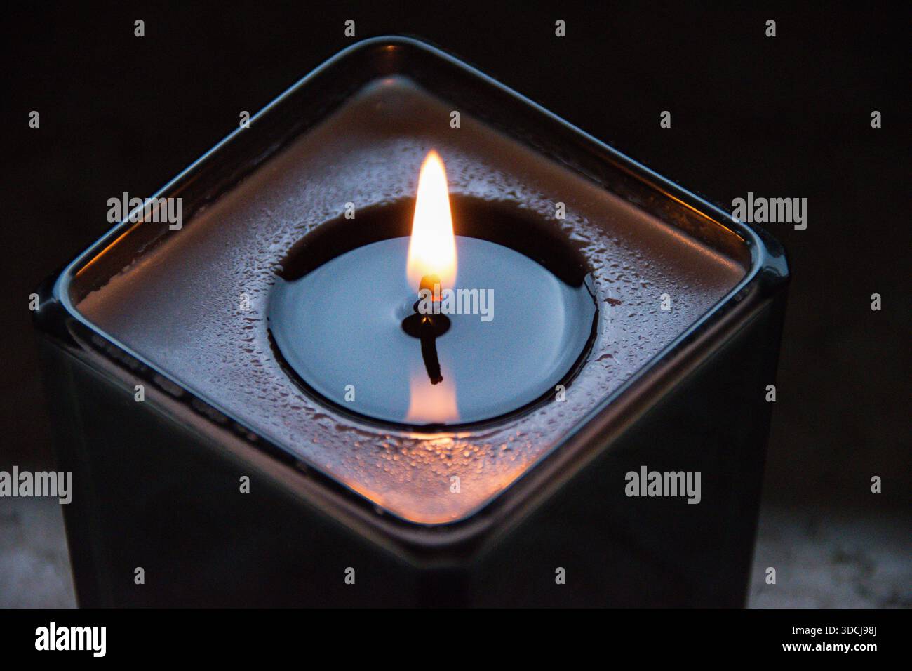 Une bougie allumée transforme instantanément l’énergie d’un espace, passant d’un éclairage fonctionnel à une expérience sensorielle profonde. Banque D'Images