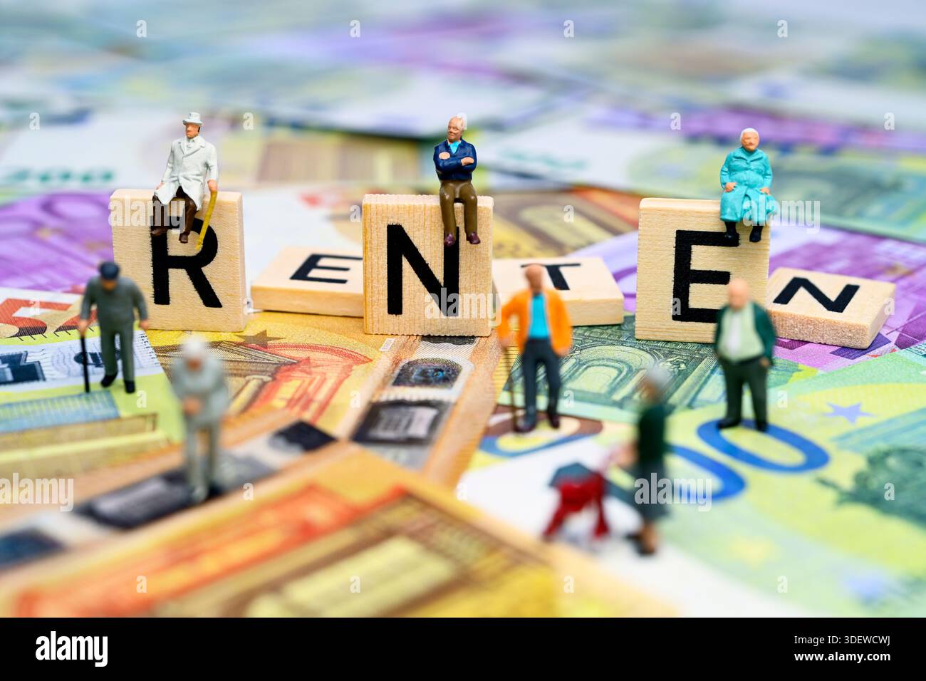 Des figurines miniatures se trouvent sur des lettres individuelles des lettres de pension de lettrage sur des billets en euros Banque D'Images