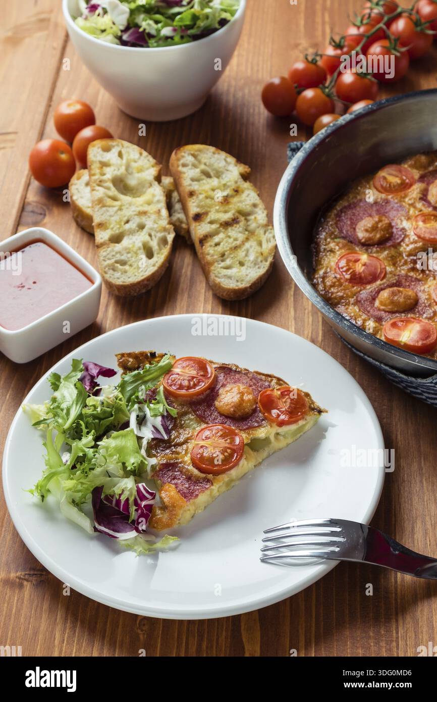 Frittata sur assiette blanche avec table de petit déjeuner Banque D'Images
