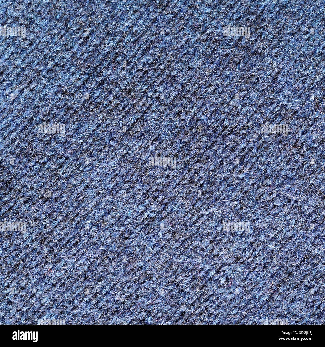 Gros plan de tissu de laine tricoté industriellement de fond de couleur bleue Banque D'Images