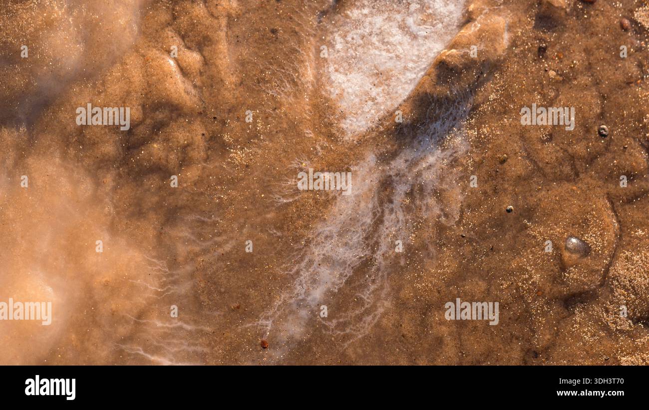 Glace gelée et texture de sable sur la côte hivernale Banque D'Images