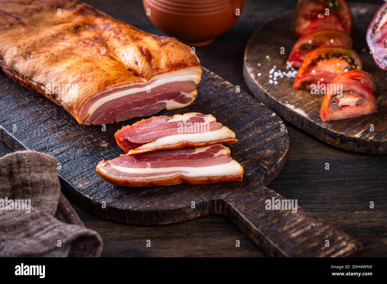Ventre de porc fumé sur planche à découper Banque D'Images
