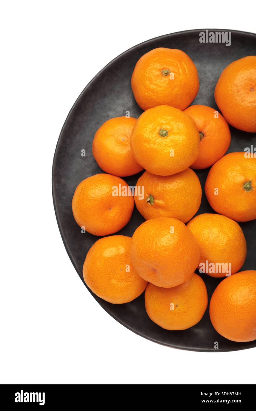 Petite mandarine orange fraîche en assiette isolée sur fond blanc. Vue de dessus Banque D'Images
