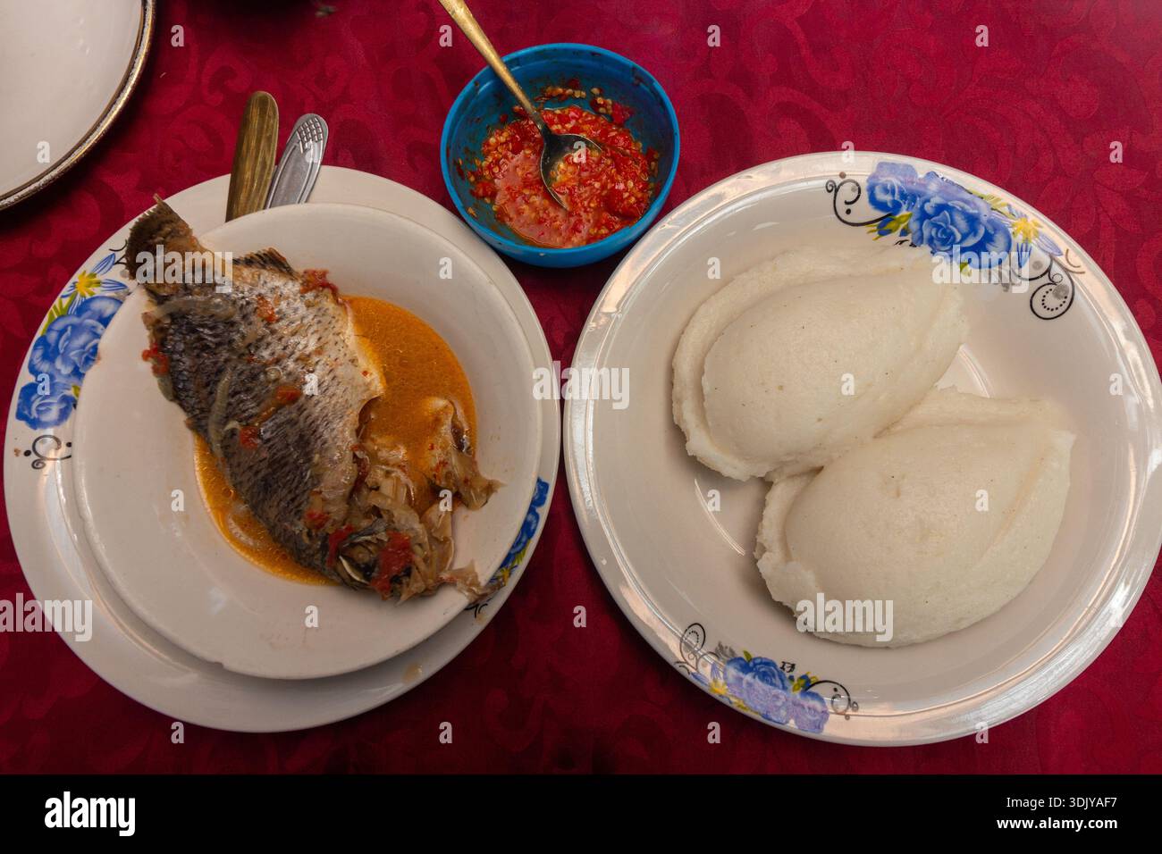 Tilapia au ragoût de tomates, servi avec Ugali (également connu sous le nom de Nshima ou Sadza) et sauce Piri-Piri Banque D'Images